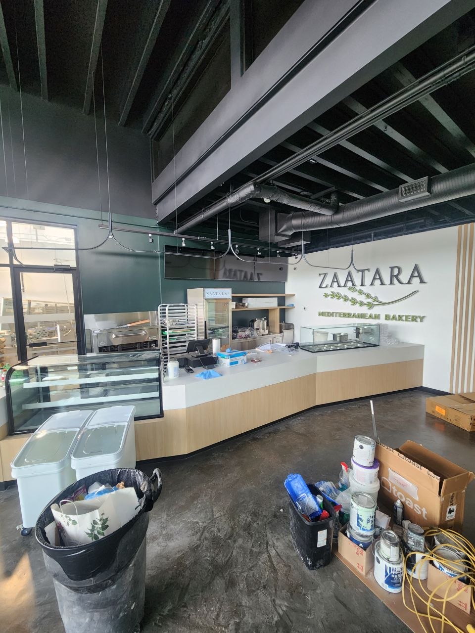 Zaatara Mediterranean Bakery front counter during final commercial fit-out work in Calgary