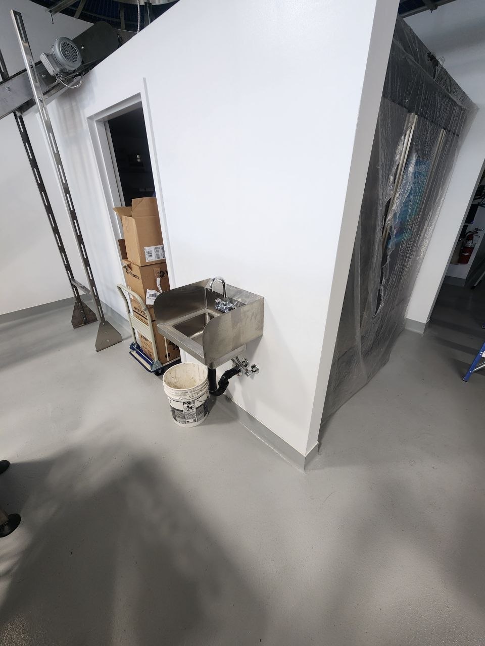 Stainless steel handwash sink installed in a commercial bakery work area